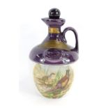 A Montrose Potteries Scotch Whiskey Decanter, the Rutherfords Blended Scotch Whiskey, with a purple