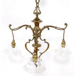 A Victorian brass three branch electrolier, the scroll supports, on chain hanging, with fluted frill