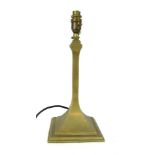 A loaded brass table lamp, on a plain column support, and out swept square base, 43cm high.