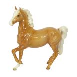 A Beswick tan horse, with black Beswick stamped to underside, 15cm high.