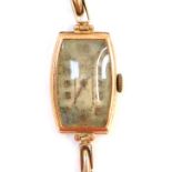 A 9ct gold ladies wristwatch, with a shaped rectangular dial on an expanding 9ct gold strap, 15g all