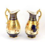 A pair of miniature Crown Derby milk jugs, each in the Imari pattern, picked out in gilt, with orang