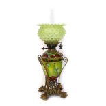 A Victorian pottery oil lamp, the green vaseline glass flared shade, a chimney on a ceramic Doulton