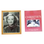 A signed copy photograph of Bette Davis, black and white, in a strut frame, together with a Christie