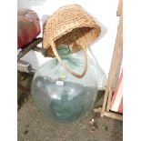 A glass carbuoy and a basket. (2)