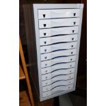 A steel twelve drawer filing cabinet.