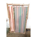 Two garden deck chairs, one with multi-coloured striped fabric, the other red and white. (2)