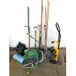 A quantity of garden tools, hose reel, diesel oil cans, etc.