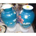 A pair of Victorian glass vases, over painted with blue ground and pink flower, 33cm high.