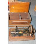 A cased Singer sewing machine, with painted gilt and floral decoration, in wooden case. (AF)