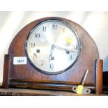 A 1950s oak cased mantel clock, with dome top and silvered dial, eight day chiming movement.