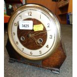 An oak cased mantel clock, with plaque presented to Mr P Ward for Hotpoint Ex Service 1955.