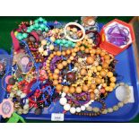 A group of costume jewellery, beaded necklaces, bangles, etc. (1 tray)