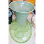 A Lovatts green ribbed vase and a green opaque glass dressing table set.