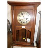 An oak cased 1920's/1930's wall clock, with eight day movement.