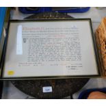 An Elizabeth II framed declaration and a resin tabletop. (2)