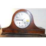 An oak cased Napoleon's hat mantel clock, with beaded and carved detailing, with a silvered dial.