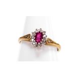 A 9ct gold pink tourmaline and diamond cluster ring, the central tourmaline stones surrounded by tin