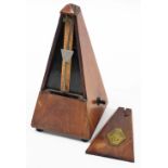 A Maelzel Paquet oak cased metronome, 22cm high.