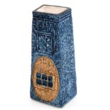 A Troika coffin shaped pottery vase, decorated with roundels and rectangles, against a blue ground,