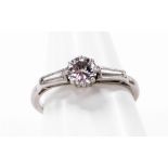 An Art Deco design diamond dress ring, the central round brilliant cut diamond in claw setting measu