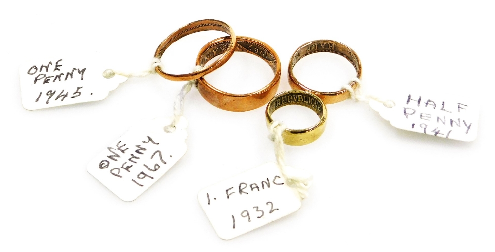 Four artisan made copper and brass coin rings, comprising a 1941 half penny, 1945 one penny, 1967 pe