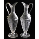A pair of Victorian cut glass claret jugs, possibly James Powell, engraved with scrolling leaves and