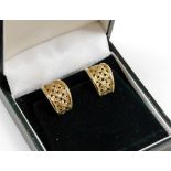 A pair of 9ct gold earrings, each rounded with tapered lattice design, on spring clip backs, 4.8g al