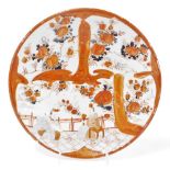 A Japanese Meiji period kutani dish, decorated with panels of flowers, blossom, and interior scene,