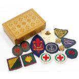 Vintage felt and brass Boy Scout badges, contained within a wooden box.