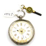 A late 19thC Swiss white metal pocket watch, open faced, key wind, the case decorated with scrolls,