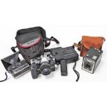 A Chinon 20PXL cine camera, an Olympus OM10 camera with a 50mm lens, an Instamatic camera 100 and a