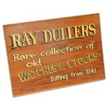 A mahogany advertising sign for Ray Dullers, Rare Collection of Old Watches and Clocks, 36cm x 51cm.