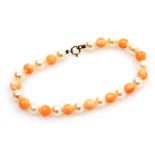 A coral and cultured pearl bracelet, on string strand with yellow metal clasp stamped 9ct, 20cm long