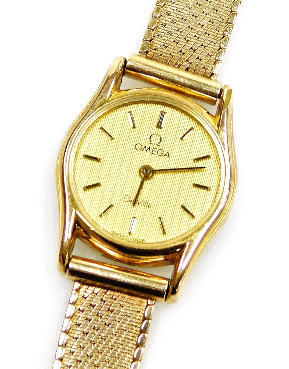 An Omega De Ville lady's 9ct gold wristwatch, with small circular watch head, on a bark effect type