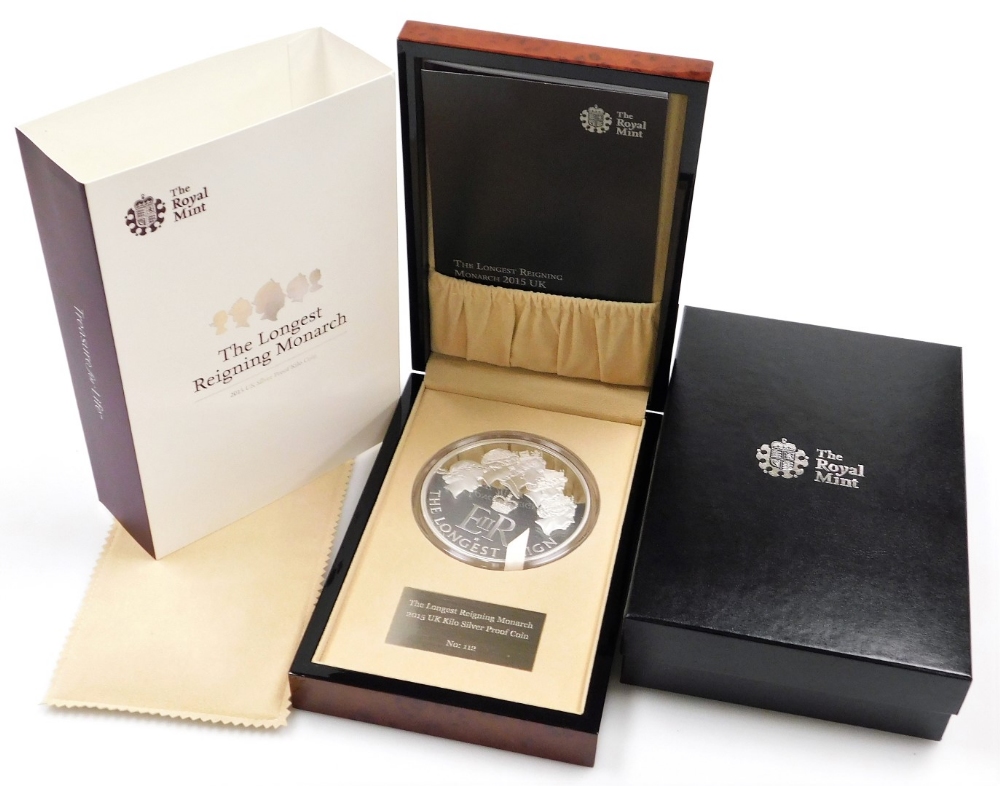 An Elizabeth II 2015 silver proof kilo coin, number 112, to commemorate the longest reigning monarch