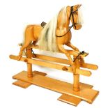A 20thC ash and pine rocking horse, with white horse hair mane and tail, indistinctly signed and dat