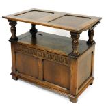 An Old Charm style oak monk's seat, the hinged lid opening to reveal a chest interior, raised on sti