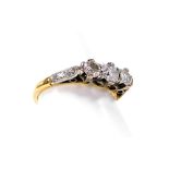 A three stone diamond dress ring, with three illusion set diamonds, each in claw setting, white meta
