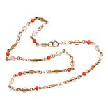 A 9ct gold necklace, set with coral and seed pearls, on modern interwoven linked chain, 18cm long, 6
