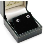 A pair of 18ct white gold cluster earrings, set with arrangement of central sapphire surrounded by t