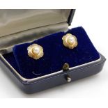 A pair of floral cluster earrings, each with a central cultured pearl with outer fan design flower,