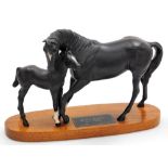 A Beswick matt black figure group of Black Beauty and foal, connoisseur model, on an oval wooden bas