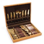 A vintage teak and brass canteen of cutlery, forty four pieces, cased.
