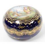 A 19thC Bohemian porcelain circular box and cover, depicting a gentleman playing a musical instrumen