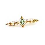 A 15ct gold and aquamarine bar brooch, with arched central section with floral design shoulders and