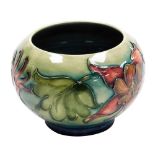 A Moorcroft pottery Columbine pattern vase, of squat bulbous form, printed marks and paper label, 8c