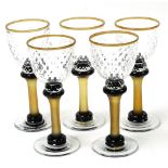 A set of five contemporary wine glasses, each with a clear honeycomb glass bowl and knop, above an i