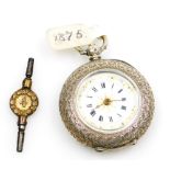 A Swiss white metal pocket watch, open faced, key wind, the case engraved with flower heads, scrolls