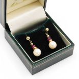 A pair of 9ct gold ruby and cultured pearl drop earrings, each drop with a faceted ruby, and culture